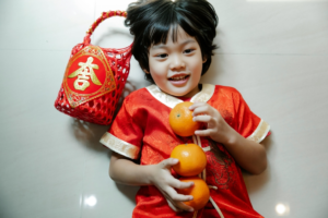 Adorable ethnic little boy holding gift basket 
