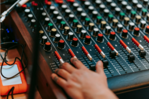 Hand of a Person Using a Sound Mixer