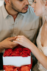 Man in White Button Up Shirt Holding Red Rose Bouquet