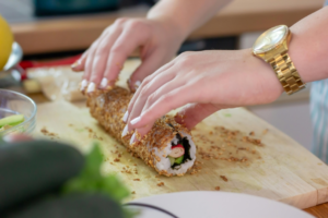 A Person's Hands Making Sushi