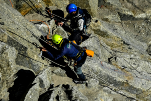 Two People Climbing a Mountain