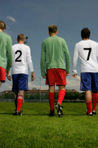 Players Walking on Grass