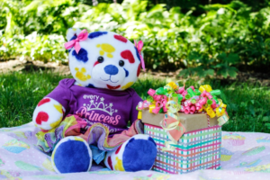 Colorful Teddy Bear Beside Gift Box
