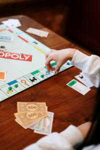 Monopoly Board Game on Brown Wooden Table
