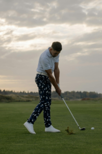 a well dressed man enjoying golf