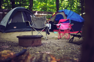 Two Pink and Gray Camping Chairs And Tents
