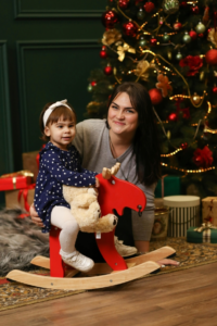 Little Girl and Woman in Front of Christmas Tree
