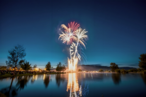 Fireworks Display Near Body Of Water For Celebration Of New Year
