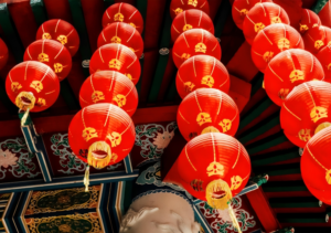 Red lanterns hanging from the ceiling of a Chinese temple
