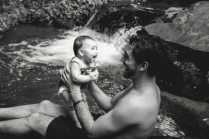 Black and White Photo of a Man Holding a Baby