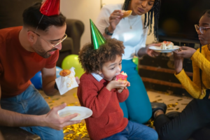 People Wearing Party Hats Busy Eating Donuts
