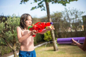 Young Boy Shooting a Water Gun
