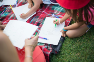 A Girl Drawing on White Paper
