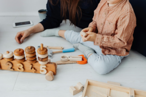 Woman and Child Playing with Wooden Toys
