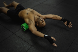 a man is doing exercise with foam roller 