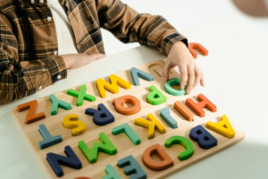 A Child Playing with an Alphabet Toy