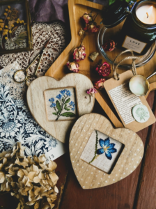 
Frames with embroidered flowers on table