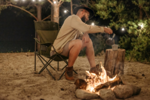 A Man in Brown Long Sleeves Sitting on Camping Chair
