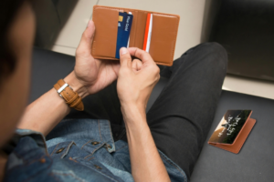 A Person Taking a Card from a Wallet