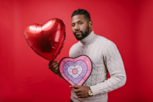 Man in White Long Sleeve Shirt Holding Valentine's Day Gifts