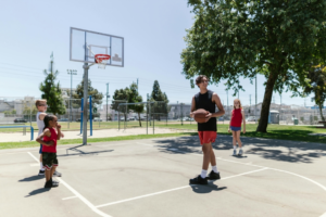 Kids Playing Basketball with Their Coach
