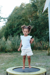 Little Girl Jumping on a Trampoline