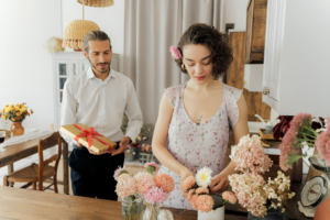 Man and Woman Holding Bouquet of Flowers