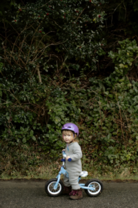 Adorable little girl riding bicycle 