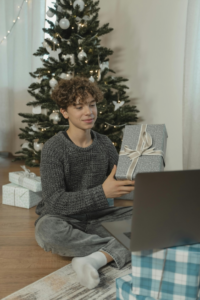 A Teenage Boy Showing a Gift Via Video Call
