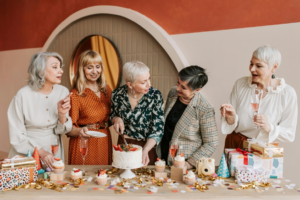 A Woman Slicing a Cake with Her Friends