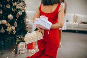 Woman Showing Christmas Presents Behind Her Back
