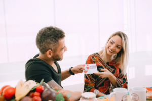 A Man Giving a Greeting Card to Girlfriend