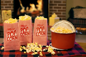 A cozy setup with fresh popcorn bags and a stovetop popcorn maker, perfect for one of the best gifts for men who enjoy home entertainment