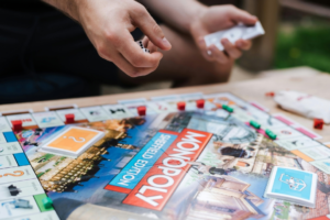 a man is playing monopoly for his entertainment