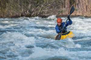 a man is taking experience in whitewater rafting