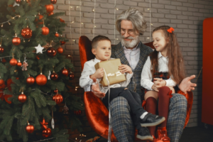 Two Children Sitting on the Lap of their Grandfather
