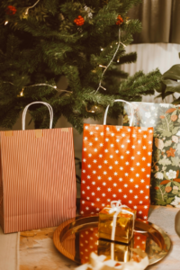 A Gold Gift Box Near the Paper Bags