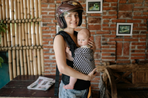 Happy Mom And Baby With Baby Carrier