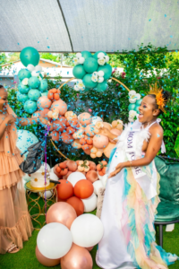 Mother-to-be Happy with Blue Confetti at Gender Reveal Party in the Garden