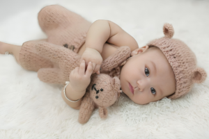 Baby in Sewed Clothes and with Sewed Teddy Toy
