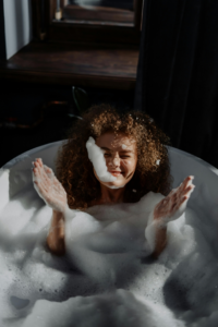 a woman is taking bubble bath with fun