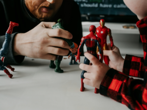 Father and Son Playing with Superheroes Toys