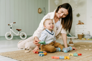 Baby Boy Sitting on Floor with Classic Toys