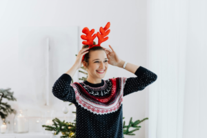 Smiling Woman Wearing A Knitted Sweater and Headdress
