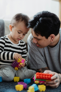 Father Playing with Toys with His Son
