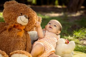 Baby Among Teddy Bear