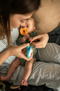 A Mother Cutting Her Baby's Nails
