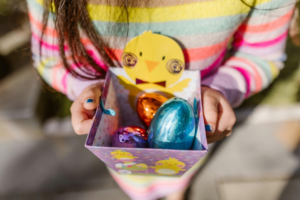 Girl Holding Chocolate Eggs in Box
