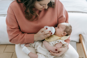 Mother feeding crying cute baby
