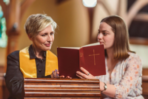 Women Looking at an Opened Bible